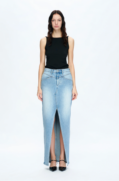 Woman wearing a black sleeveless top and light blue denim skirt on a white background