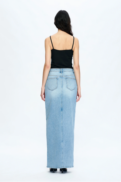 Woman wearing a long denim skirt on a white background